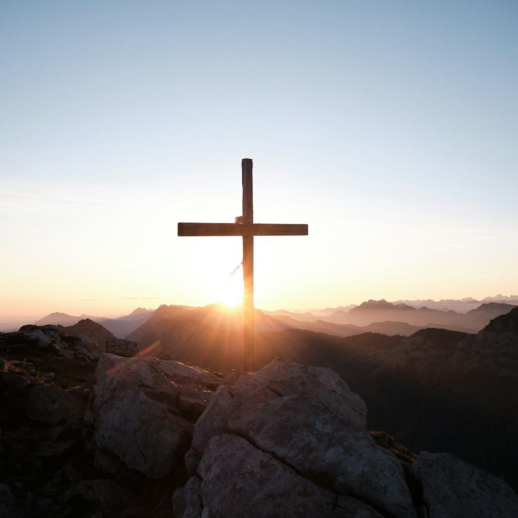 brown cross on brown rock during daytime